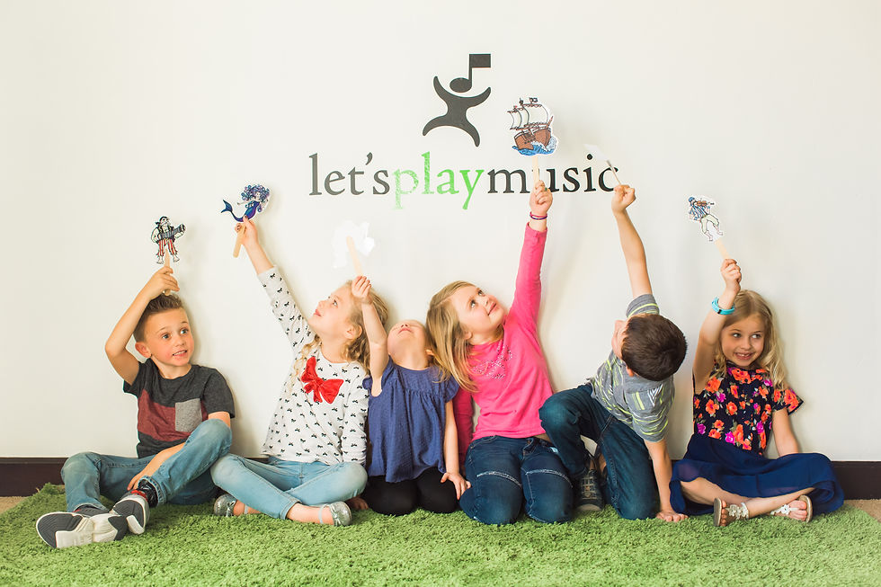 Children participating in a musical storytelling activity with puppets during a Let's Play Music class.