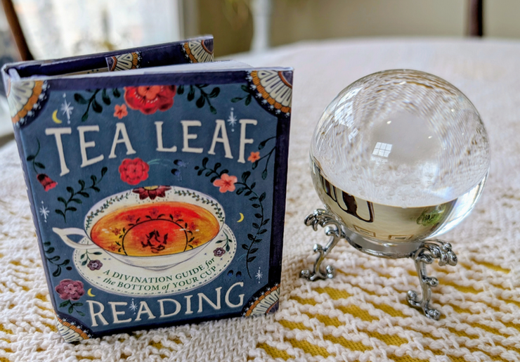 A delicate tea cup being read for secrets at the bottom of the cup.