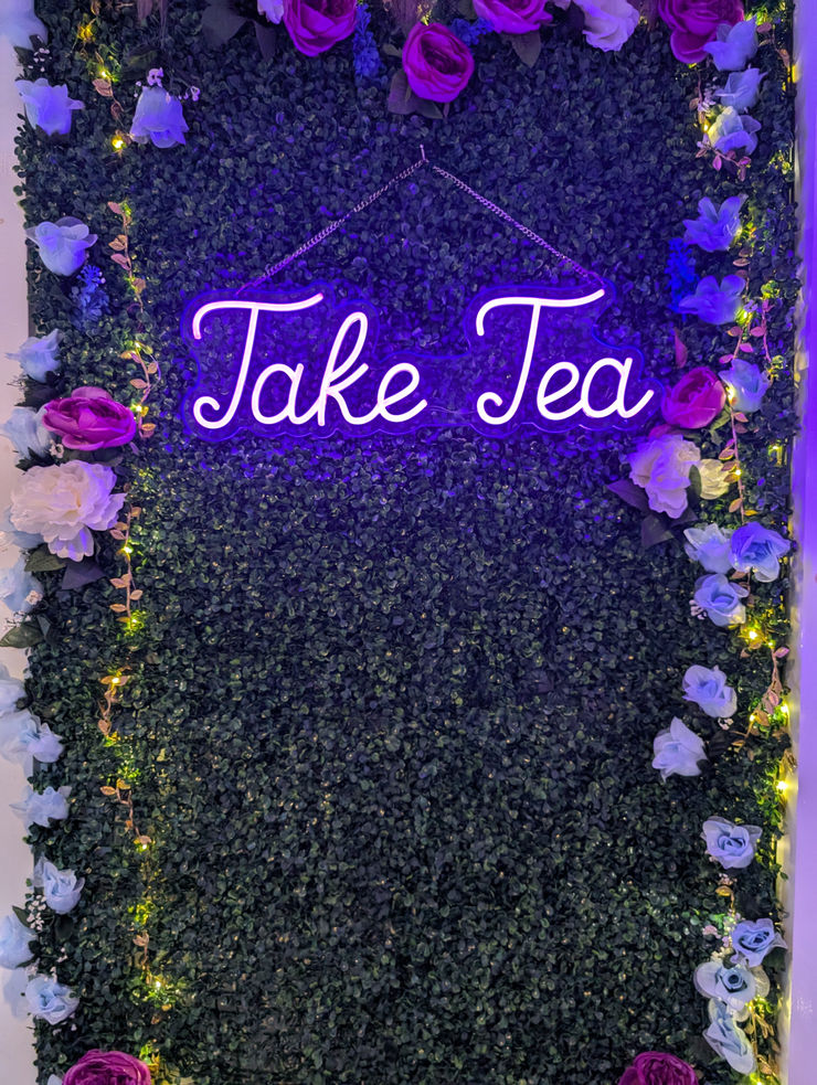 A cozy and enchanting tea room interior with soft mystical lighting and vintage herbal jars.