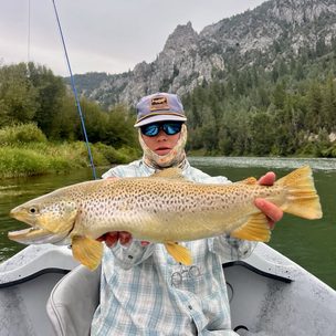 Western River Anglers client holding a large trout during a guided fly fishing trip in Wyoming.