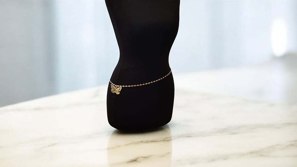 Thumbnail: Elevate your style with our Butterfly Belly Chain from With Love, The Gift Shop. This gold tone chain with a butterfly charm