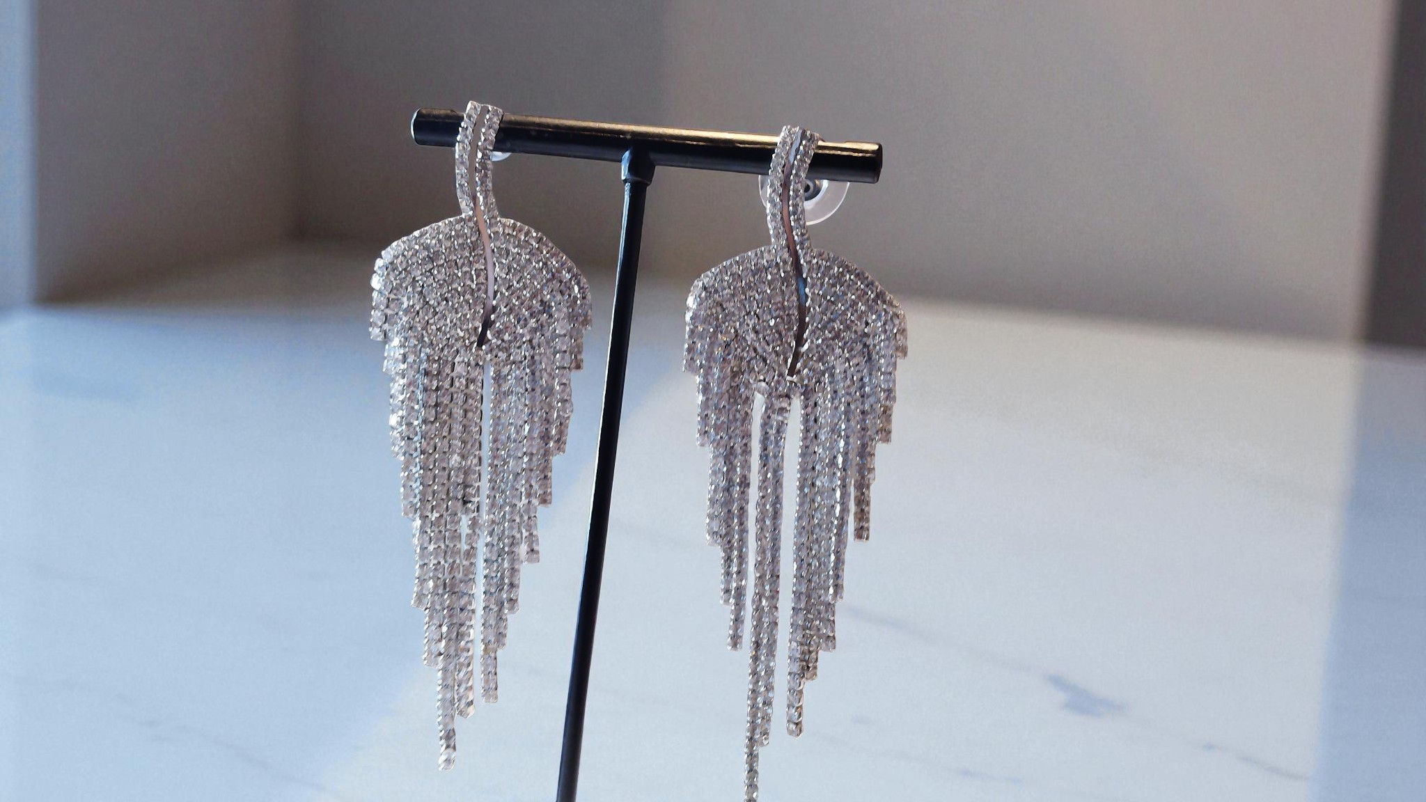 Discover the charm of The Leanne Earring at With Love, The Gift Shop. These rhinestone-encrusted leaf-shaped earrings offer t