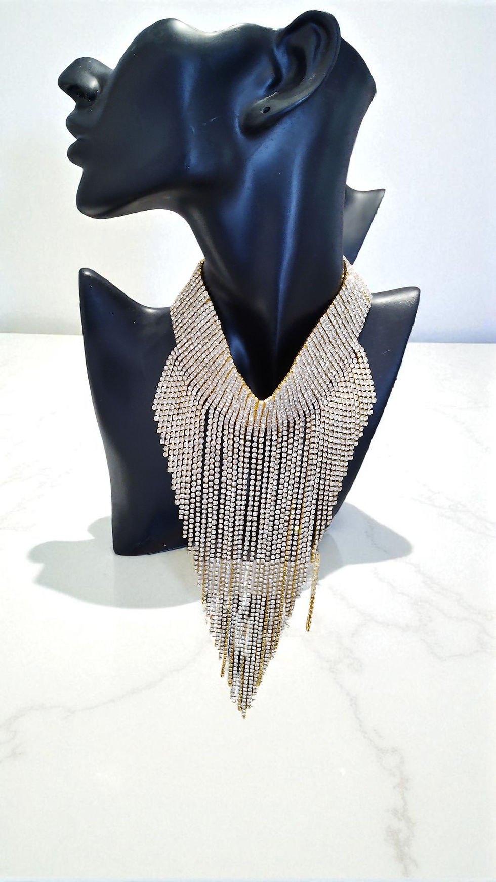 Discover elegance with The Denise Necklace in gold or silver. This choker-style necklace features rhinestones cascading in a