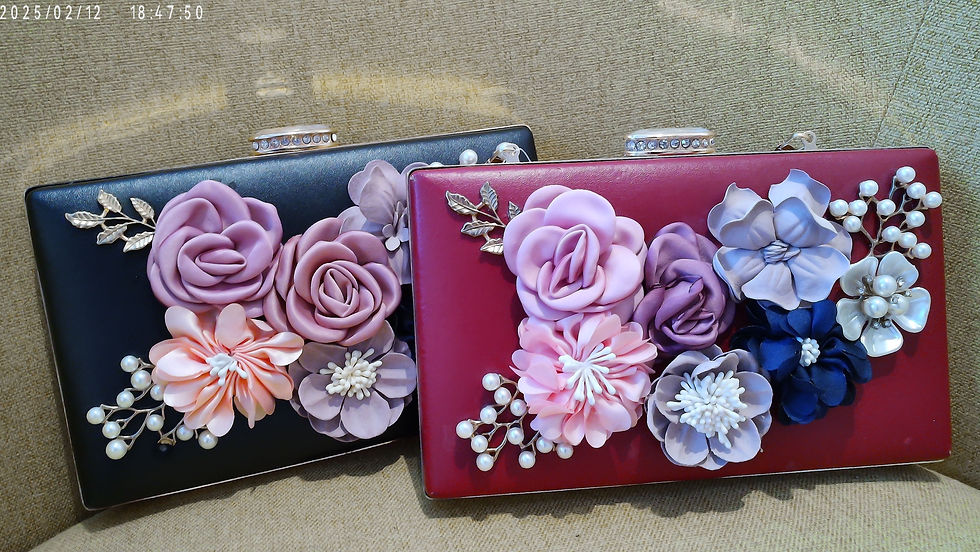 Discover the Roberta Floral Clutch, available in red, black, or blue. This soft leather bag, with hand-made floral appliques