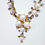Thumbnail: a rhinestone and pearl encrusted necklace and earring set