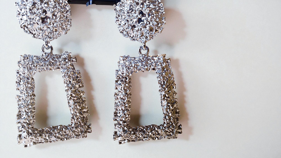 Thumbnail: Available in black, silver, and rose gold, these nugget-style earrings are fun, radiant, and versatile. At With Love, The Gif