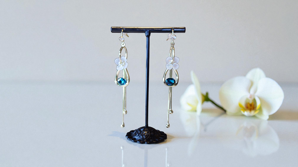 Experience elegance with The Eve Petal Earrings from With Love, The Gift Shop. Featuring a tulip design with a blue stone, th