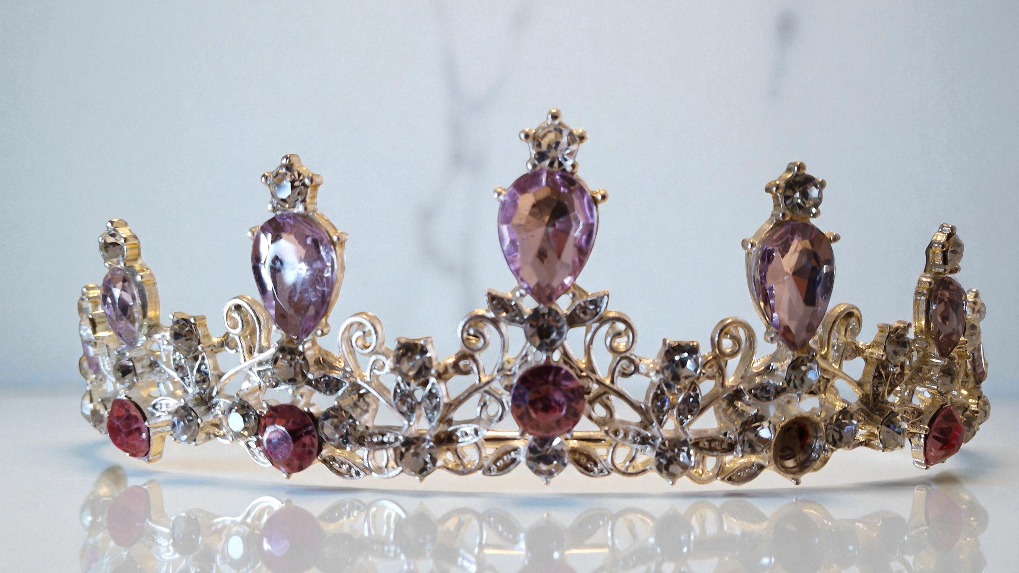 At With Love, discover the enchanting Shania Children's Tiara. Adorned with pink and lilac stones and rhinestones set in silv