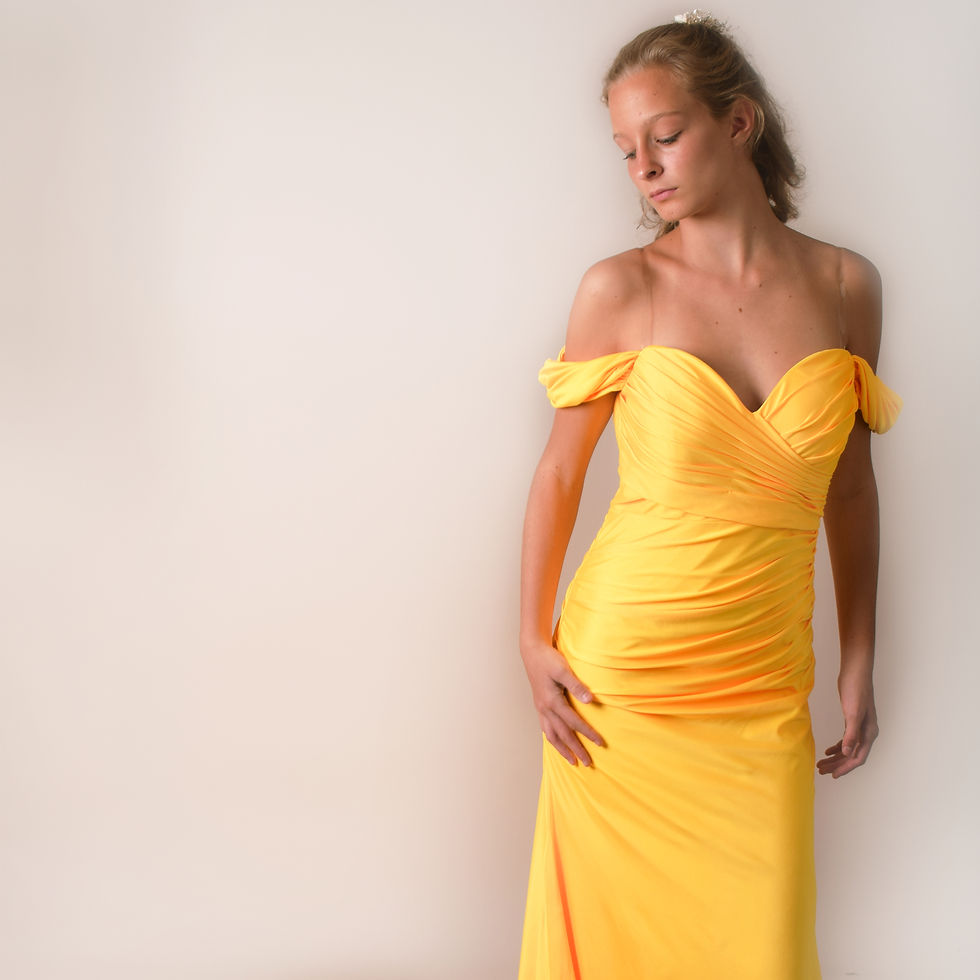 An original creation by Joan of London for BWTR-A South East London Bridal Shop. A prom dress in a vibrant yellow, plunging b