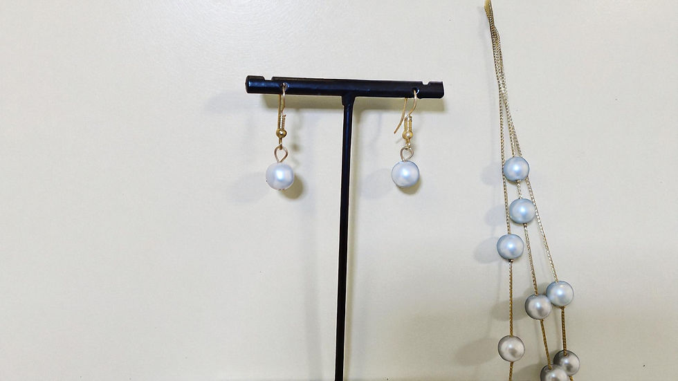Thumbnail: Discover The Monica Pearls, a beautiful necklace, earrings, and bracelet set, designed to enhance your elegance. On a gold br