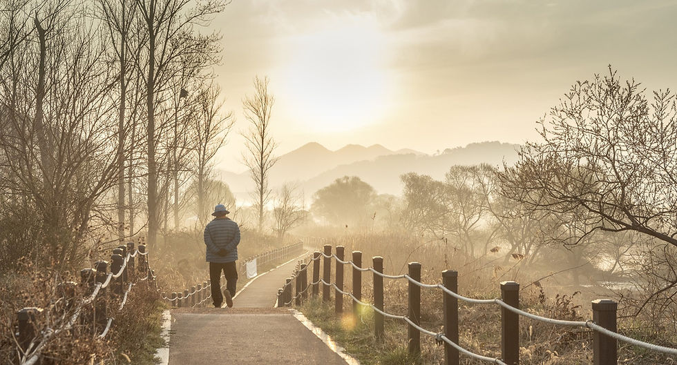 Old man walking on pathway in cold morning,