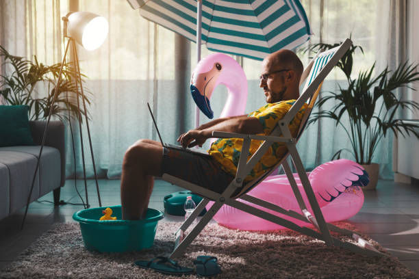 Man working from home with a beach stuff.