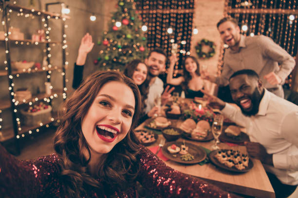 Close up photo of cheerful fellows in formal wear sit around table enjoying their meals.