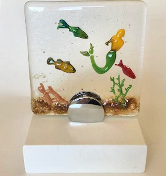 Small fused glass ‘aquarium with 3 fish and mermaid with blond hair swimming in glass bubbles with corian white base