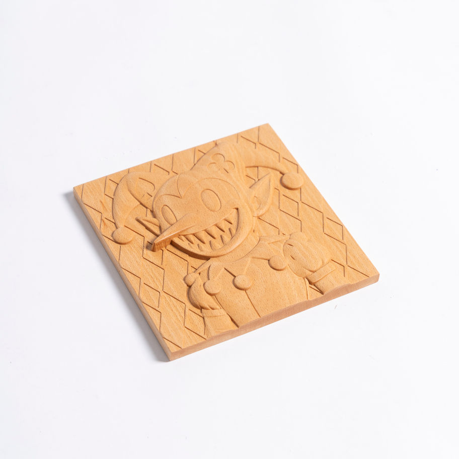 Angled view of carved beech wood jester wall art showing cartoon-style clown design and gothic horror carving details