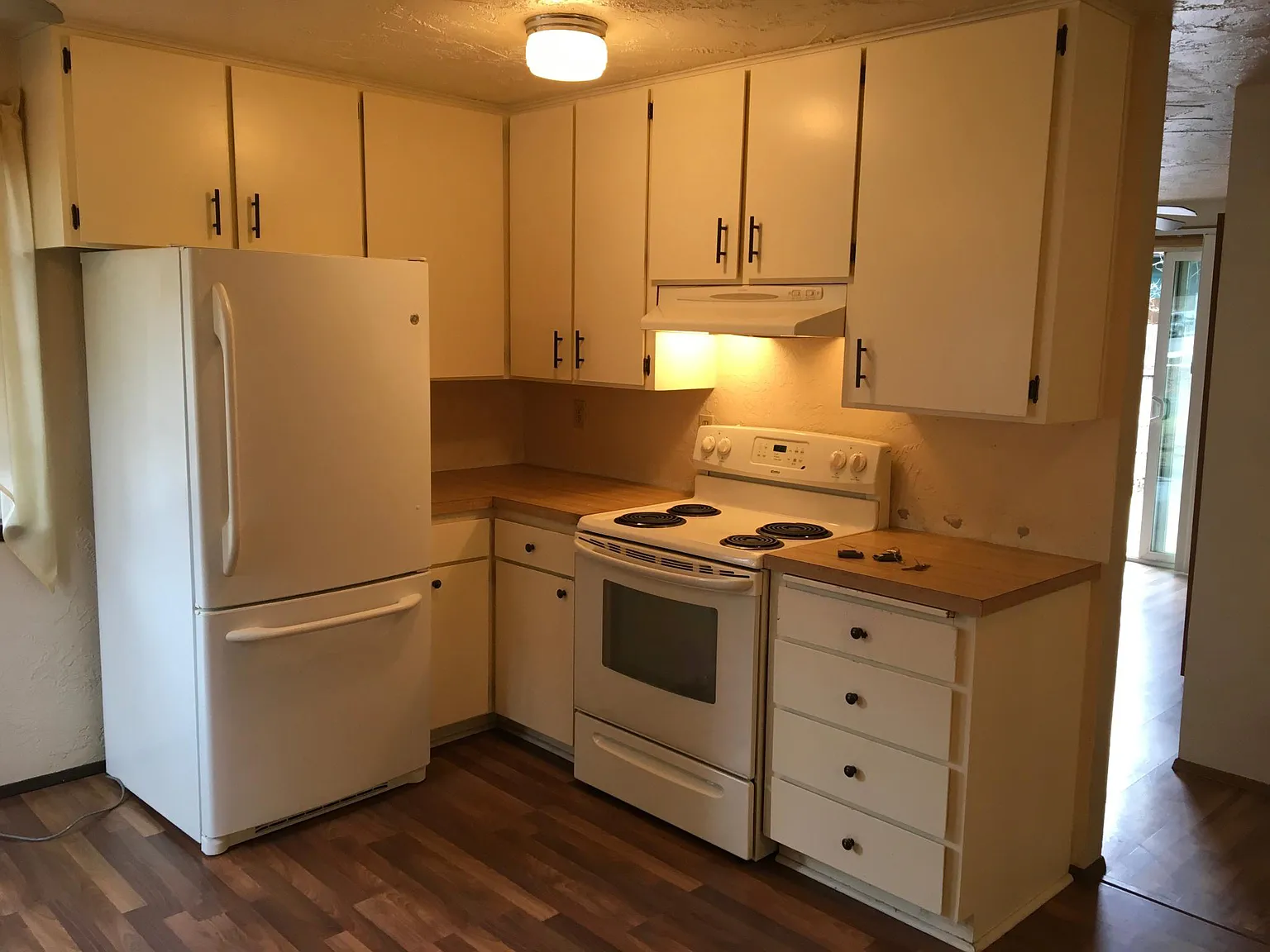 Before photo - Kitchen fridge & stove