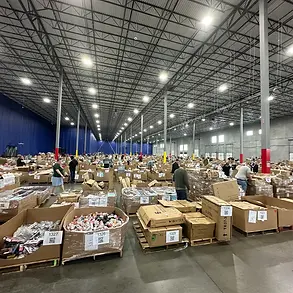 Warehouse floor stacked with palletized liquidation inventory staged for live in-person auction