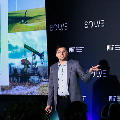Saxon Metzger presenting on stage at MIT Solve