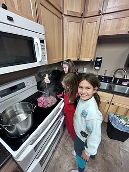 Children cooking in kitchen, part of an independent learning daily schedule