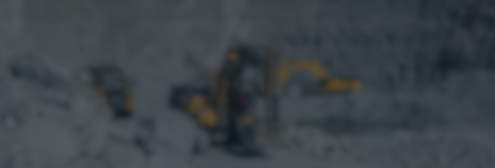 mining equipment in a quarry with a slightly blurred decorative overlay.