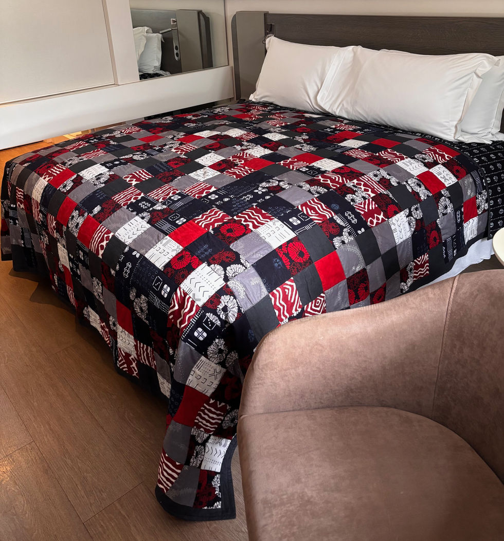 A red, silver and blue quilt displayed at a Western hotel