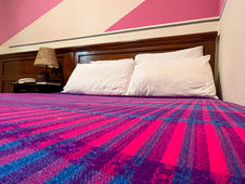 colorful bedcover at Arbol de Fuego Eco-Hotel