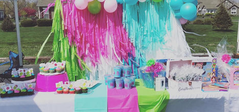 Colorful party table with balloons and streamers