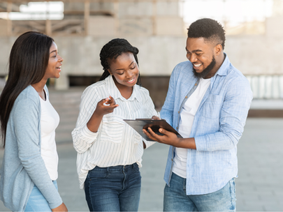 3 people chatting, one of them is taking notes on a clipboard