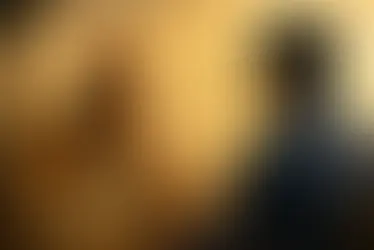 Ancient Indian strategist Chanakya attentively listening to a modern salesperson during a conversation, symbolizing customer understanding before selling. Warm golden background with subtle communication icons, representing trust, listening, and consultative sales.