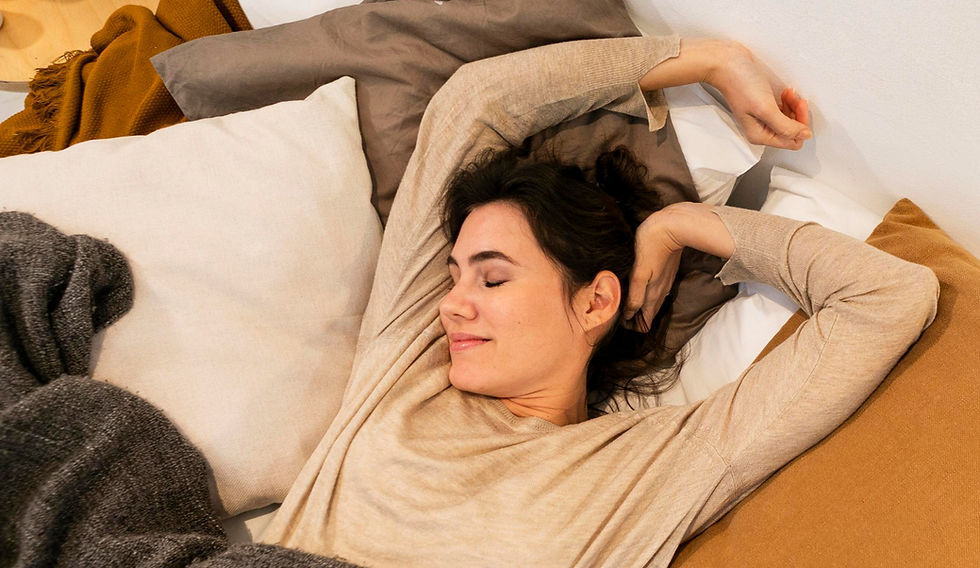 Woman with dark hair and light skin stretching, sleeping, waking up from nap