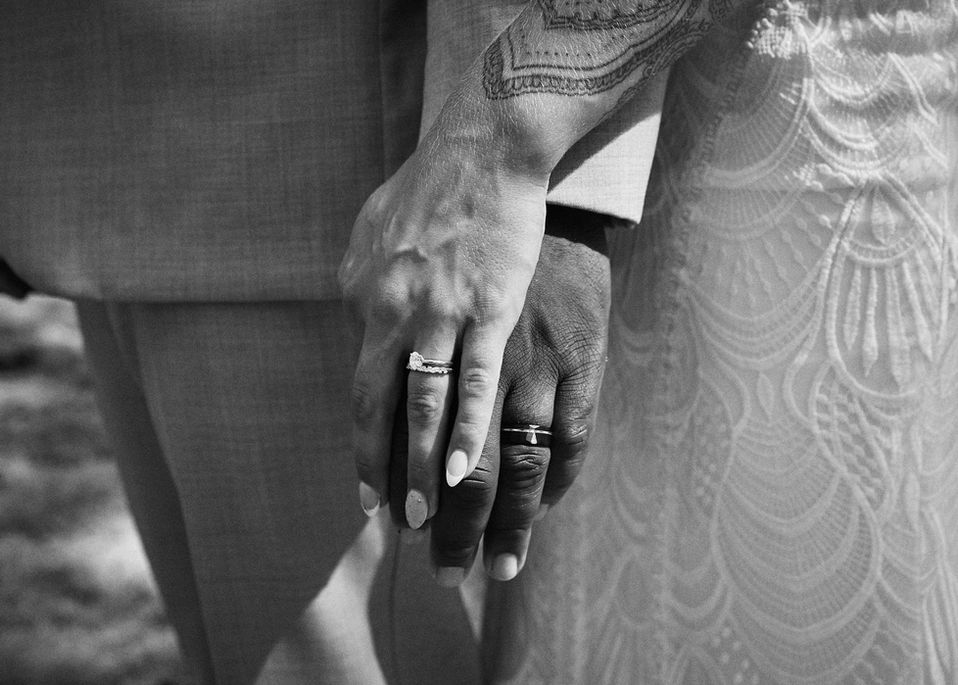 Close-up of wedding rings on moss-covered forest floor, captured by a Comox Valley and Campbell River wedding photographer, perfect for engagement photos, couple photography, and detail shots on Vancouver Island, highlighting natural textures, vibrant greens, and intimate wedding details.