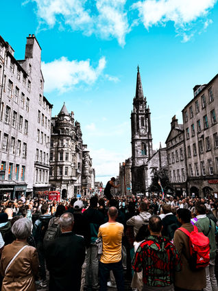a crowd of people are gathered in front of a building that says ' abercrombie & fitch ' on it