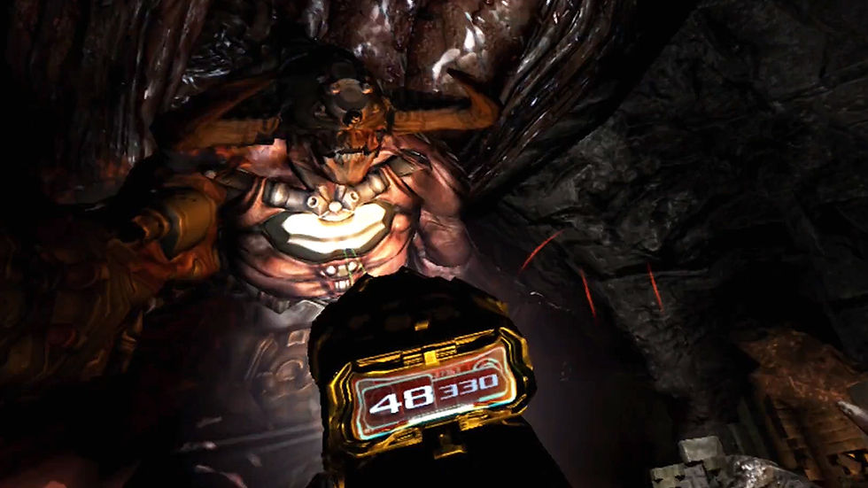 Screenshot from virtual reality game DOOM 3: VR Edition, a Cyberdemon enemy towers over the player, illuminated by a flashlight. The player aims a futuristic gun at the enemy. There is a glowing interface on the gun that displays ammo.