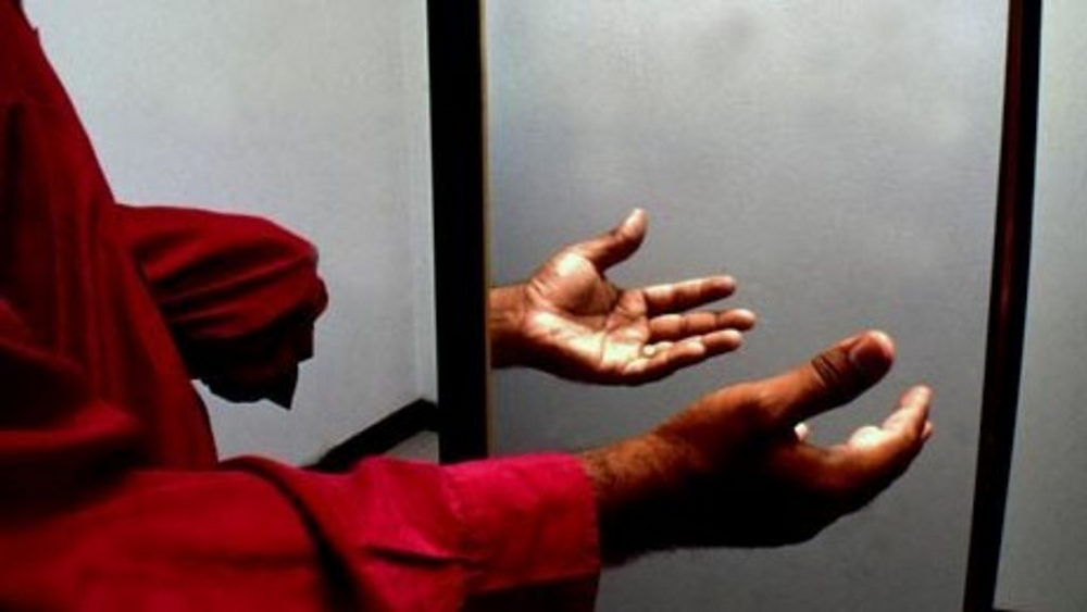 A photograph of an amputee holding out their right hand, as well as their left forearm, where their left hand has been amputated. A carefully positioned mirror "reflects" back the right hand in the place where the amputated left hand would appear.