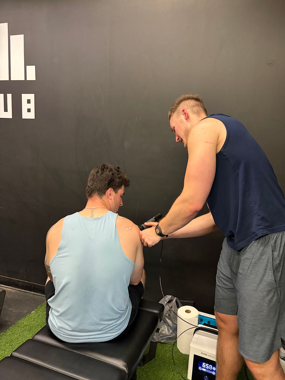 Dr. Jacob demonstrating Shockwave Therapy at a local gym!