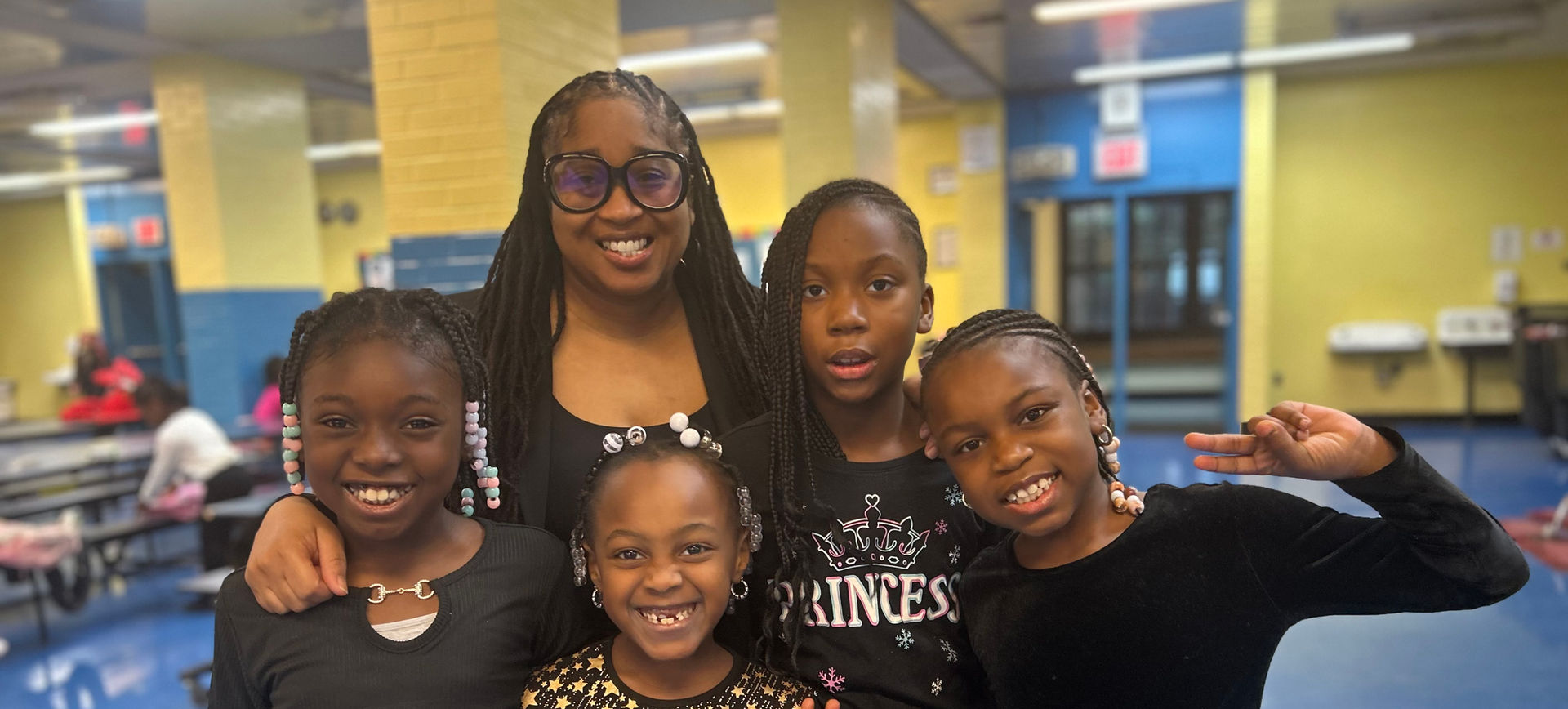 Ms. Moodie and third grade students dressed in all black for the holiday show.