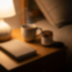 Peaceful bedside table with OOH BEHAVE magnesium product, journal, and warm ambient light for a calming nightly ritual