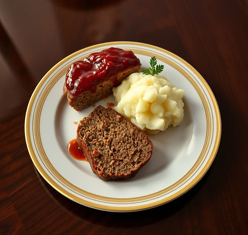 I nice white dinner plate with a gold rim sitting on a dark wood shiny table. On the plate