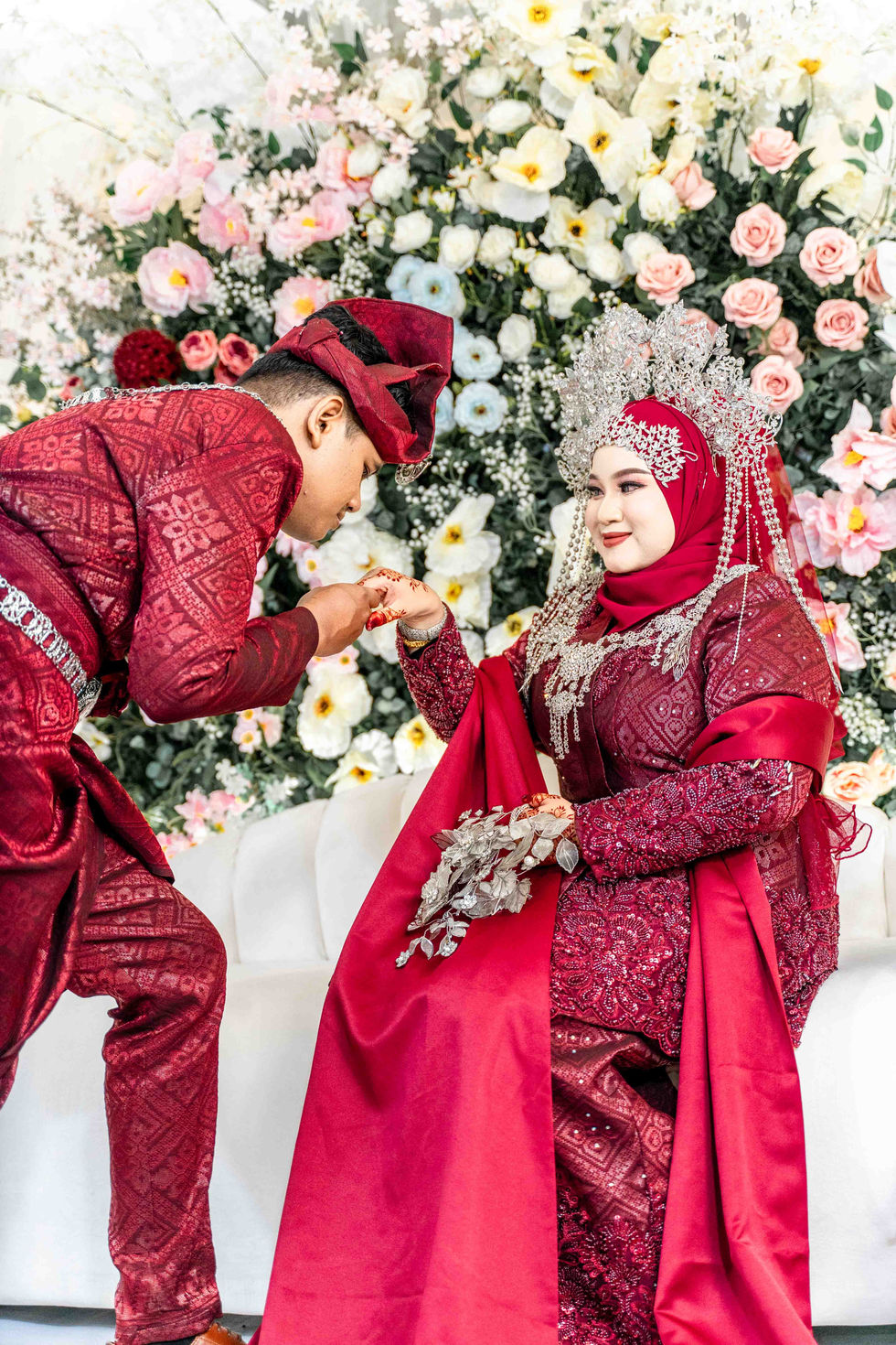groom lightly kiss bride's hand