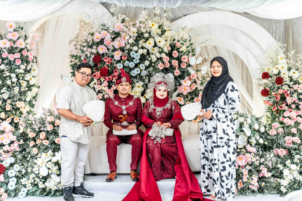a bride and groom pose for a picture with their family