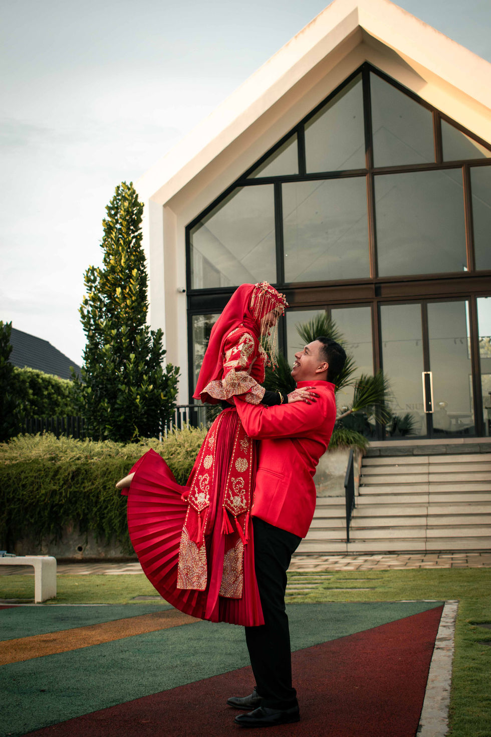 mix race couple, groom lifting bride
