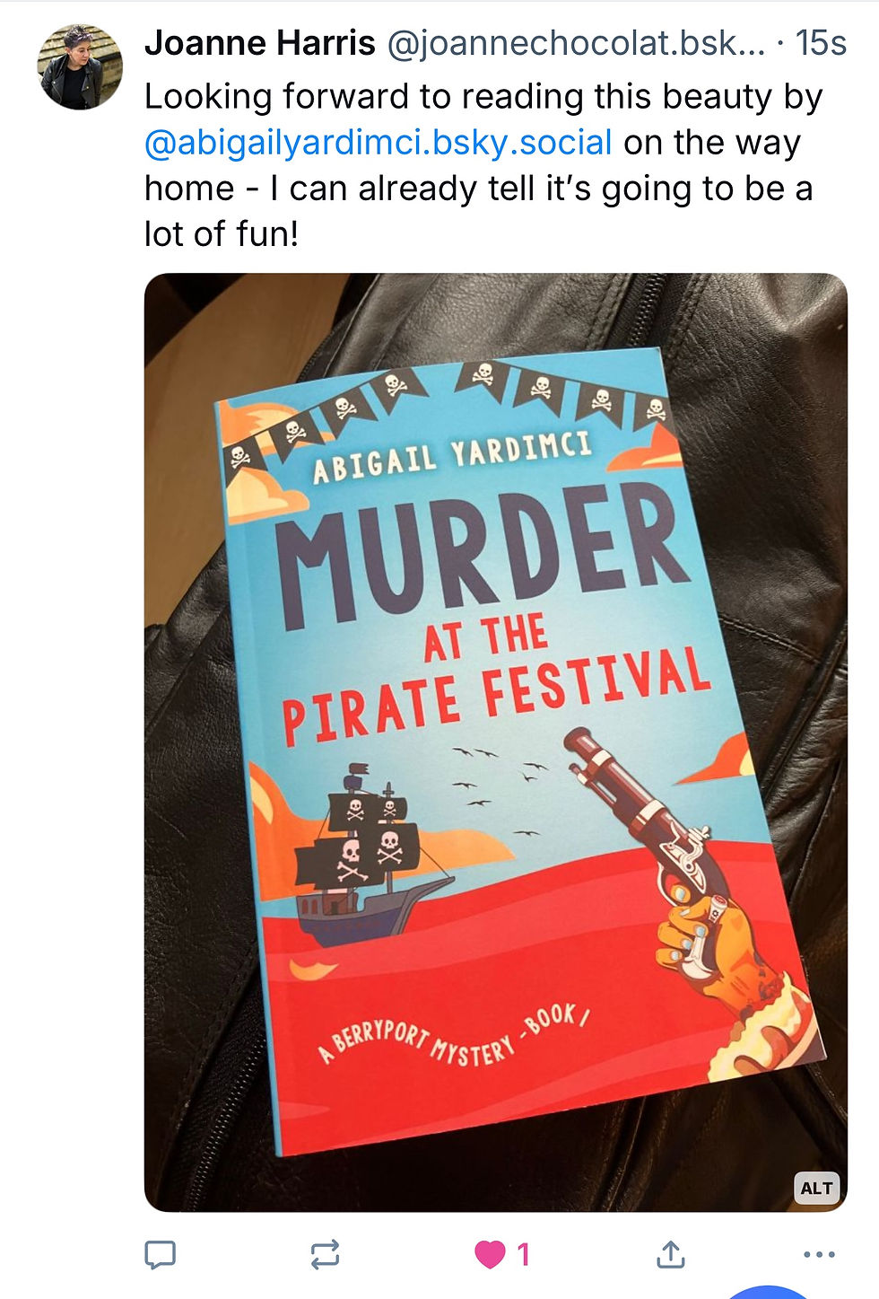 Screenshot of Joanne Harris's BlueSky post picturing a copy of Murder at the Pirate Festival and a caption saying she is looking forward to reading it on the train home