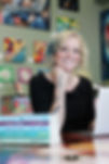 Abi sitting at her writing desk and smiling