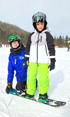 Snowboard Instructor with a snowboard student in a private lesson.