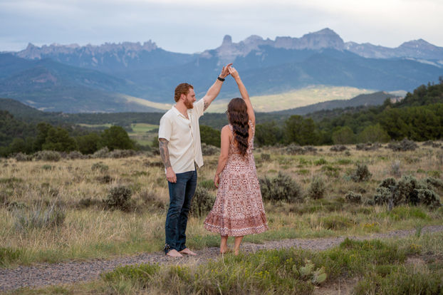 Image of a couple dancing with mountains in the background.