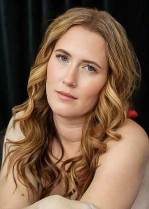 Portrait of a woman with flowing hair in red negligee.