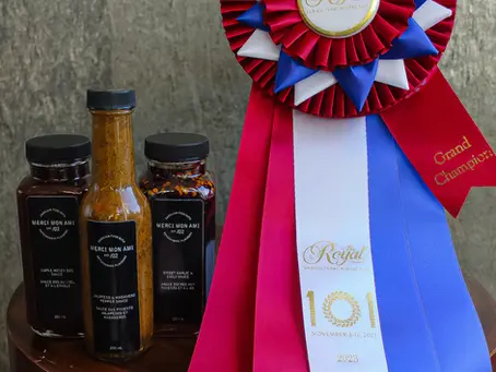 Merci Mon Ami Sweet Chili and Garlic Sauce bottle, the Grand Champion award‑winning sauce at the Royal Winter Fair, showcasing rich sweet chili and garlic flavor