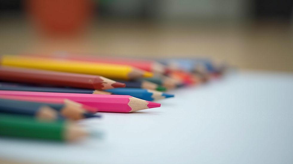 Close-up view of a child’s therapy tools including colored pencils and paper
