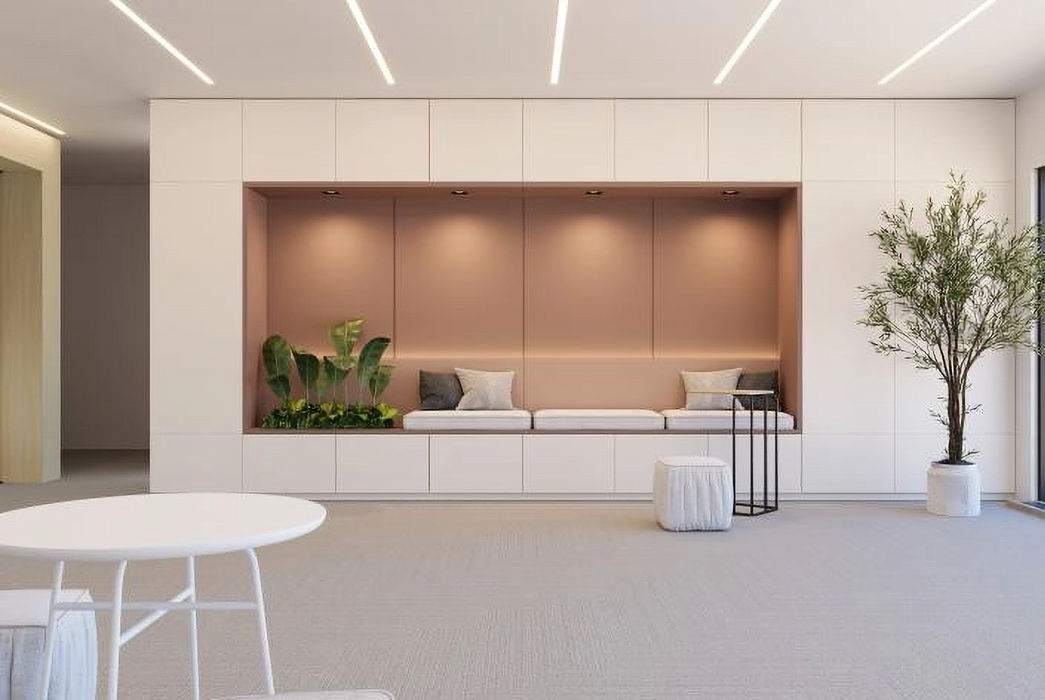 Modern office waiting area with built-in bench seating, plants, and a tree.
