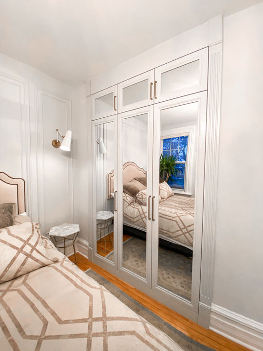 Tall mirror doors on built in custom closet.